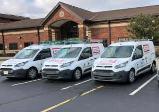 CincyAlarm vans outside of building